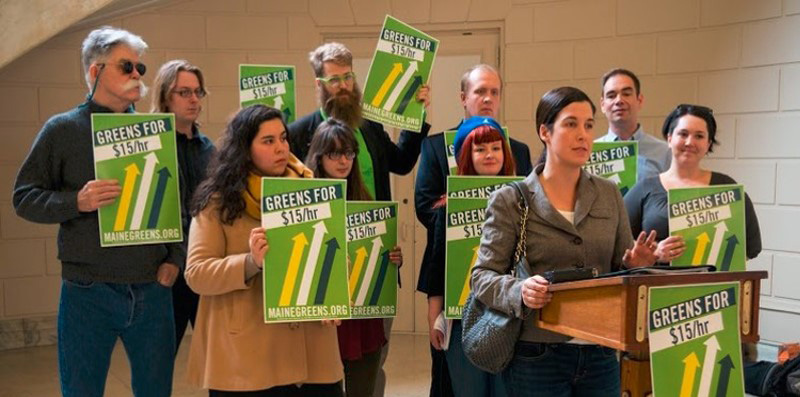group of people holding volunter signs